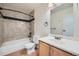 Bathroom with tiled shower and tub, toilet, and vanity with wood cabinets at 14462 E Mississippi Ave # B, Aurora, CO 80012