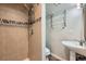 Well-lit bathroom features a tiled shower and a pedestal sink at 14462 E Mississippi Ave # B, Aurora, CO 80012