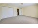 Bedroom featuring a closet with sliding doors and neutral carpet flooring at 14462 E Mississippi Ave # B, Aurora, CO 80012