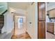 Entryway featuring hardwood floors, a staircase, and doorway into the spacious living area at 14462 E Mississippi Ave # B, Aurora, CO 80012