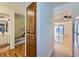 View of the home's entryway with wood floors leading to a living space and staircase at 14462 E Mississippi Ave # B, Aurora, CO 80012