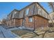 Corner view of a brick two-story townhouse featuring a well-maintained lawn and exterior features at 14462 E Mississippi Ave # B, Aurora, CO 80012