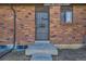 Close-up of a front door with a security screen and visible house number, set in a brick wall at 14462 E Mississippi Ave # B, Aurora, CO 80012