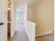 Bright hallway with neutral tones leads to carpeted bedroom and bathroom at 14462 E Mississippi Ave # B, Aurora, CO 80012