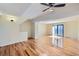 Bright living room featuring hardwood floors, neutral walls, and a sliding glass door to the outside at 14462 E Mississippi Ave # B, Aurora, CO 80012