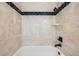 Close-up of the shower area with decorative tile and black fixtures at 14462 E Mississippi Ave # B, Aurora, CO 80012