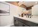 Double vanity bathroom with modern fixtures and large mirror at 16559 Peak Way, Broomfield, CO 80023