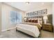 Cozy bedroom with a bed, nightstands, and window at 16559 Peak Way, Broomfield, CO 80023