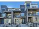 Modern three-story townhome with blue door and balcony at 16559 Peak Way, Broomfield, CO 80023