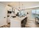 Contemporary kitchen with white cabinets and large island at 16559 Peak Way, Broomfield, CO 80023