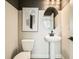 Modern powder room with pedestal sink and oval mirror at 16559 Peak Way, Broomfield, CO 80023