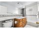 Bathroom with traditional cabinets, soaking tub, and custom tile accents at 3308 S Birch St, Denver, CO 80222