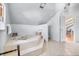 A large, well-lit bathroom featuring a step-up tub and neutral tile flooring at 3308 S Birch St, Denver, CO 80222