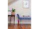 Bedroom decor with a blue velvet bench, wooden floors, and painting hanging on the wall at 3308 S Birch St, Denver, CO 80222