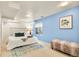 Basement bedroom with bright blue accent wall, window, and stylish decor at 3308 S Birch St, Denver, CO 80222