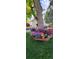 Lush landscaping featuring a tree with a seating platform and colorful flowerbeds surrounding the base at 3308 S Birch St, Denver, CO 80222