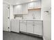 Laundry room with utility sink, shaker cabinets, and washer at 3308 S Birch St, Denver, CO 80222