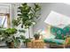 Close up of the living room showing plants and a couch with floral pattern. The lighting is natural from a large window at 3308 S Birch St, Denver, CO 80222