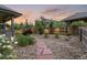 Landscaped backyard featuring stone pathway, privacy fence, and mature trees at 6597 Club Villa Rd, Parker, CO 80134