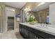 Elegant bathroom featuring double sinks, granite countertops, and a separate walk-in shower at 6597 Club Villa Rd, Parker, CO 80134