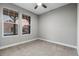 Cozy bedroom with neutral-colored walls, carpet, and bright windows offering neighborhood views at 6597 Club Villa Rd, Parker, CO 80134