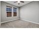 Well-lit bedroom featuring neutral carpeting, walls, and windows, offering a comfortable and peaceful atmosphere at 6597 Club Villa Rd, Parker, CO 80134