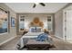 Comfortable bedroom with ceiling fan, matching nightstands, and decorative wall hangings above the bed at 6597 Club Villa Rd, Parker, CO 80134