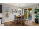 Bright dining area with seating for four, natural light and access to the outdoor patio at 6597 Club Villa Rd, Parker, CO 80134