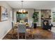 Dining area with seating for four, a fireplace in the background and a view of the outdoor patio at 6597 Club Villa Rd, Parker, CO 80134