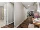 Inviting hallway with hardwood floors leads to the living area with a fireplace and a bathroom on the left at 6597 Club Villa Rd, Parker, CO 80134