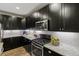 Close up of the kitchen area featuring granite countertops, stainless appliances, and subway tile backsplash at 6597 Club Villa Rd, Parker, CO 80134