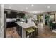 Modern kitchen featuring dark cabinetry, stainless steel appliances, granite countertops, and hardwood floors at 6597 Club Villa Rd, Parker, CO 80134