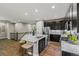 Well-lit kitchen featuring a large island with seating, stainless steel appliances, and modern finishes at 6597 Club Villa Rd, Parker, CO 80134