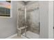 Stylish shower with glass doors, built-in bench, and tiled walls, providing a relaxing bathing experience at 6597 Club Villa Rd, Parker, CO 80134