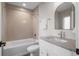 Bright bathroom featuring a tub with tile surround, updated vanity, and modern fixtures at 2140 S Ash St # 102, Denver, CO 80222