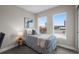 Bright bedroom with two large windows offering great views, featuring blue striped bedding at 2140 S Ash St # 102, Denver, CO 80222