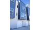 Modern townhome showcasing a contemporary design with blue and gray accents, large windows, and a one-car garage at 2140 S Ash St # 102, Denver, CO 80222