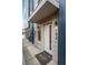 Front entrance featuring a stylish front door, exterior lighting, and a welcoming entry rug at 2140 S Ash St # 102, Denver, CO 80222
