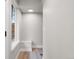 Bright hallway with hardwood floors, storage, and natural light from the large window at 2140 S Ash St # 102, Denver, CO 80222