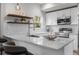 Bright kitchen with stainless steel appliances, open shelving, and modern countertops at 2140 S Ash St # 102, Denver, CO 80222