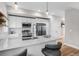 Modern kitchen featuring white cabinets, stainless steel appliances and countertop bar seating at 2140 S Ash St # 102, Denver, CO 80222