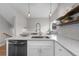 Bright kitchen island with stainless steel appliances, granite countertops, and modern lighting at 2140 S Ash St # 102, Denver, CO 80222