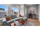 Bright living room features stylish gray sofa, hardwood floors, and an abundance of natural light at 2140 S Ash St # 102, Denver, CO 80222