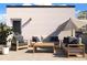 Furnished roof deck with comfortable seating and shade perfect for outdoor gatherings at 2140 S Ash St # 102, Denver, CO 80222