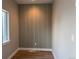 Bright room features a modern accent wall and wood-look flooring at 2140 S Ash St # 102, Denver, CO 80222