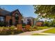 Charming homes line a peaceful street with manicured lawns and beautiful landscaping on a sunny day at 2140 S Ash St # 102, Denver, CO 80222