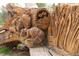 Intricate wood carving featuring detailed depictions of woodland animals, including owls and raccoons at 2140 S Ash St # 102, Denver, CO 80222