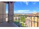 Scenic balcony view showcasing lush green spaces, rooftops, and distant mountain views at 1062 Rockhurst Dr # 302, Highlands Ranch, CO 80129