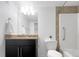 Bright bathroom featuring a granite countertop, a modern vanity, and a shower-tub combo at 1062 Rockhurst Dr # 302, Highlands Ranch, CO 80129