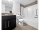 Bathroom features a modern vanity, toilet, and shower/tub combo with updated tiling at 1062 Rockhurst Dr # 302, Highlands Ranch, CO 80129